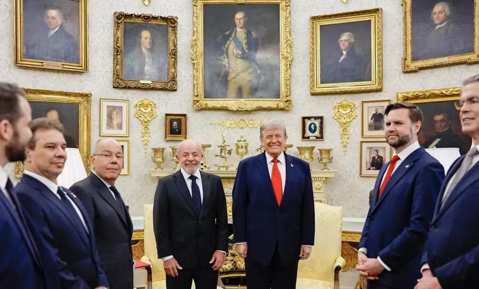 A group photograph inside the White House Portrait Room. Presidents Donald Trump (L) and Luiz Inácio Lula da Silva (R) stand in the center, flanked by representatives from both countries and surrounded by historic, gilded-framed portraits.